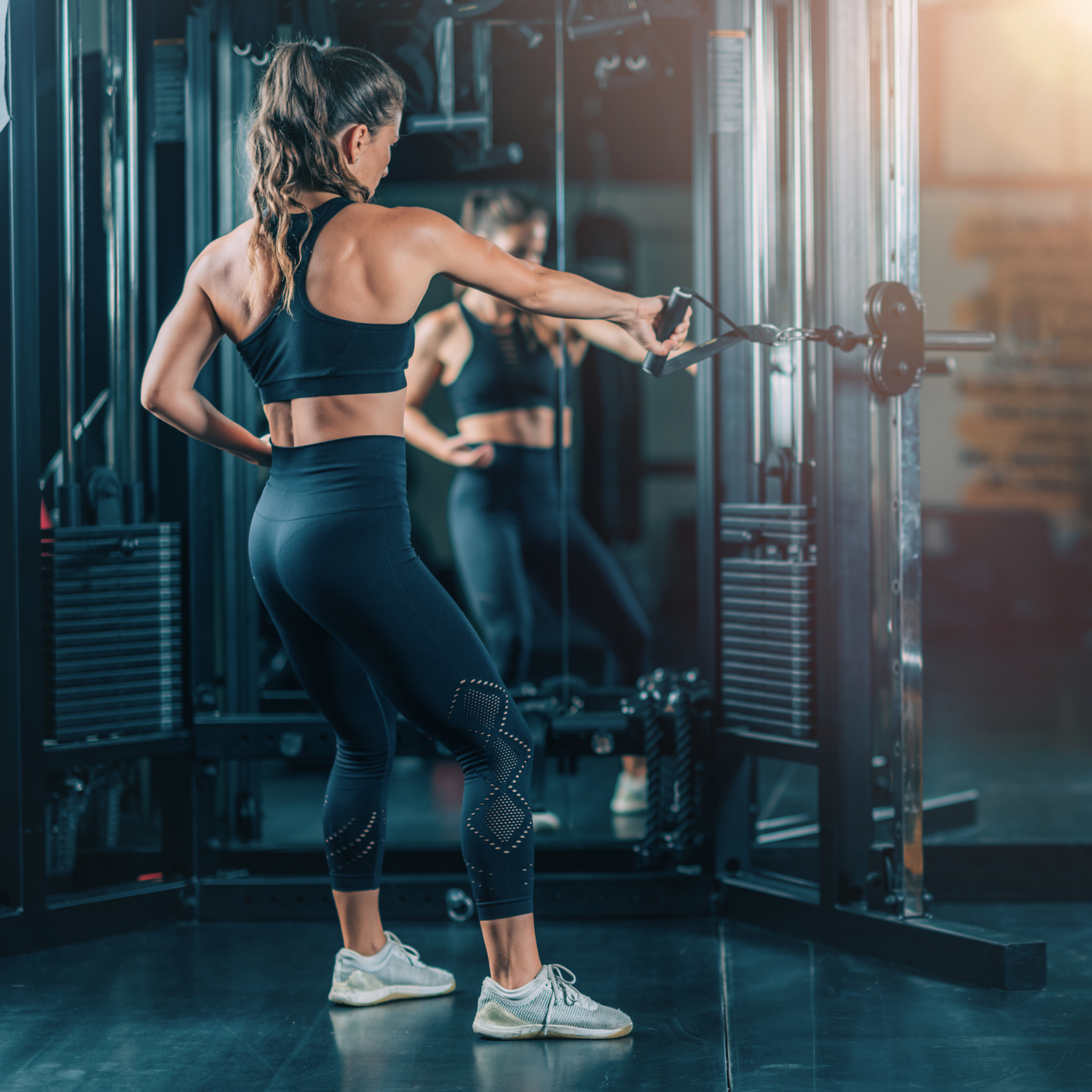 Woman Doing Exercise on a Machine in a Gym